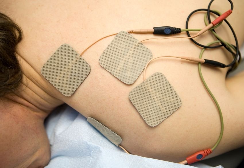Close-up of electrotherapy pads on thigh muscles